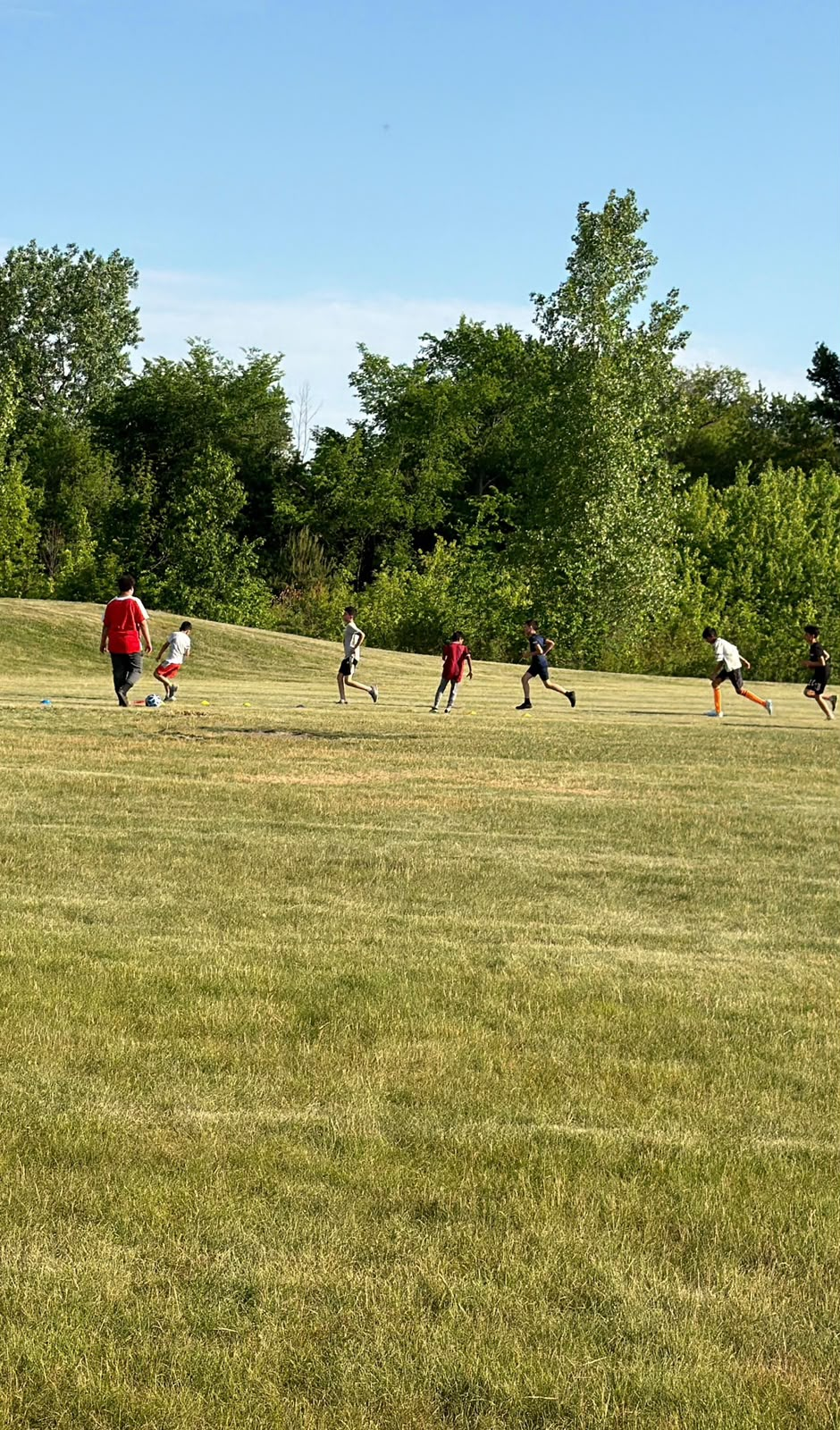Boys sprinting through a conditioning drill at Al-Fursan Soccer Academy in Oak Creek